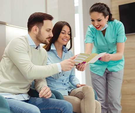 Medical provider handing brochure with payment options to patients