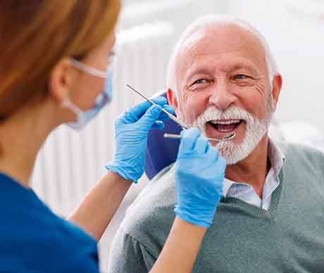 Man smiles at dentist