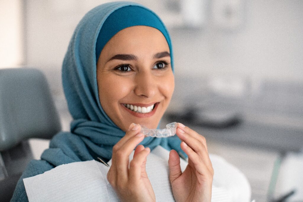 Lady smiles with Invisalign clear aligner